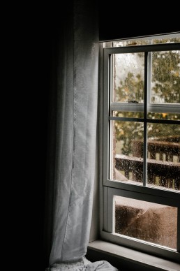A rain covered window in an early spring day.