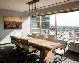 Sunlight streams through a set of energy efficient windows in an office board room.